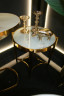 Стол золотистый со стеклянной столешницей под мрамор